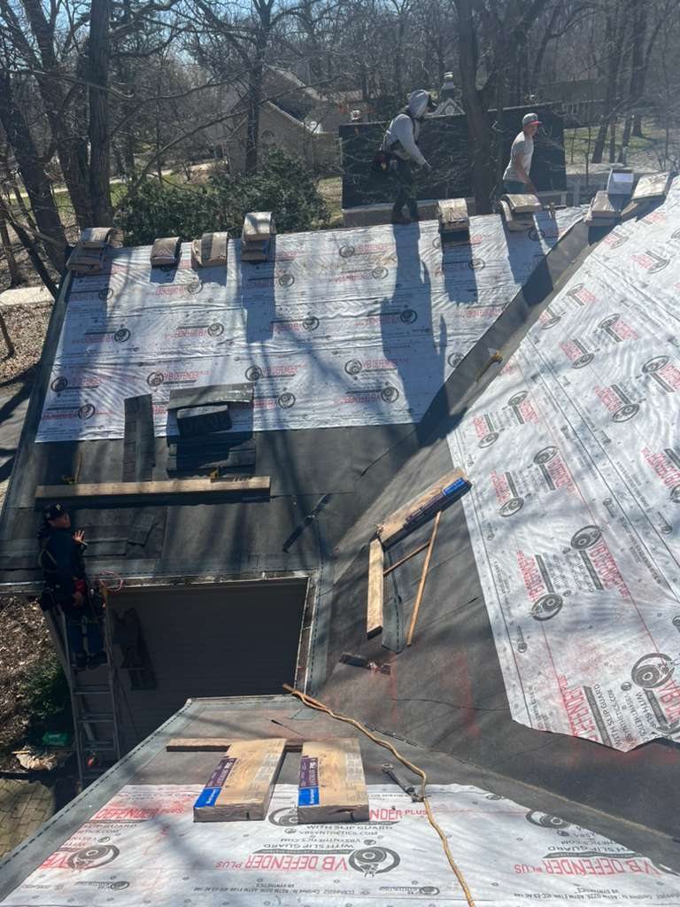 RX crew working along the roof edge and gutter line of a home in the Chicago suburbs