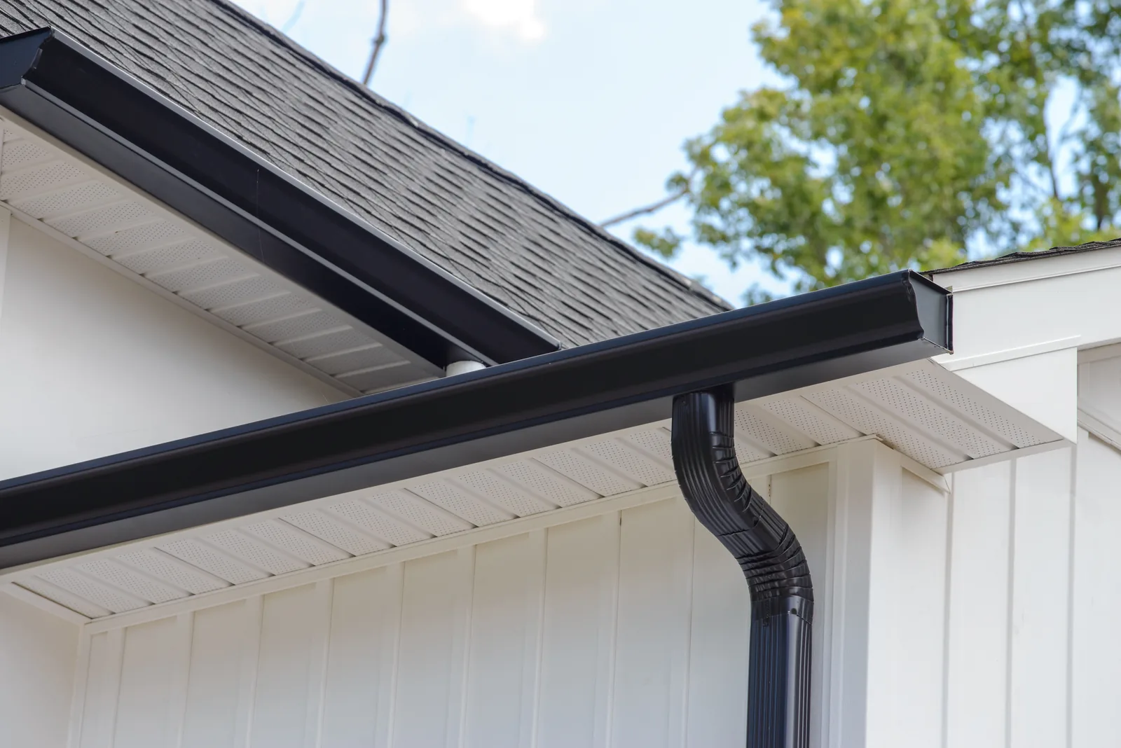 RX crew working along a roofline and gutter run on a home in the Chicago suburbs