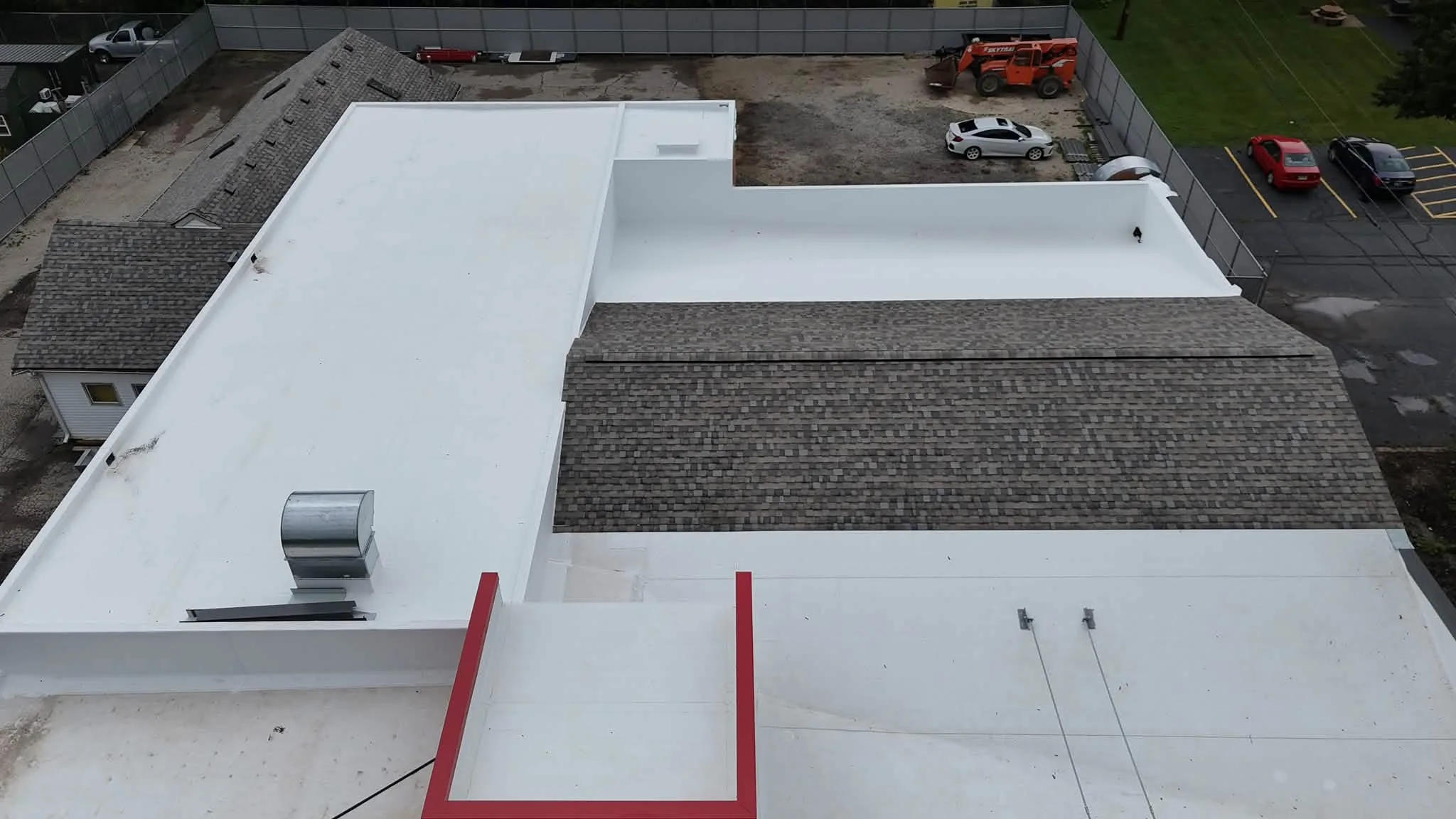 Commercial flat roof replacement with new white TPO membrane and a shingled slope